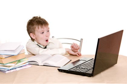 surprised by the boy at the computer isolated on white background