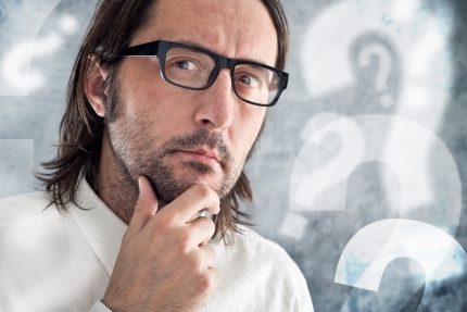 Businessman thinking and questioning. Portrait of thoughtful business person.