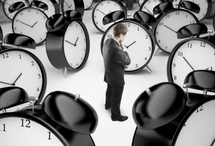 thoughtful businessman and alarm clocks